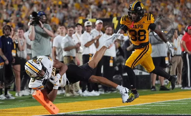 Missouri wide receiver Cayden Lee, left, scores past Arkansas-Pine Bluff defensive back Na'il Johnson (38) during the first half of an NCAA college football game Thursday, Sept. 3, 2026, in Columbia, Mo. (AP Photo/Jeff Roberson)