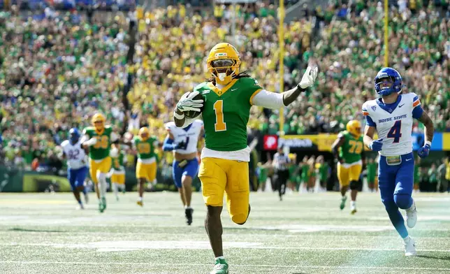 Oregon wide receiver Dakorien Moore (1) celebrates his touchdown run during the second half of an NCAA college football game against Boise State, Saturday, Sept. 5, 2026, in Eugene, Ore. (AP Photo/Lydia Ely)