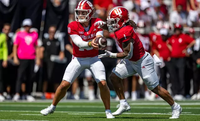 Indiana quarterback Josh Hoover (10) hands off to running back Turbo Richard (1) during the first half of an NCAA college football game against North Texas, Saturday, Sept. 5, 2026, in Bloomington, Ind. (AP Photo/Doug McSchooler)