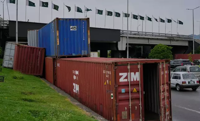 Shipping containers placed by authorities along side on a highway for seal off an area ahead of a plan protest march by the supporters of imprisoned former Prime Minister Imran Khan demanding his release, in Islamabad, Pakistan, Monday, Sept. 28, 2026. (AP Photo/Anjum Naveed)