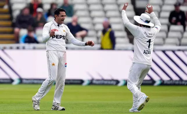 Pakistan's Muhammad Abbas, left, celebrates the wicket of England's Ben Duckett on day four of the third Test in Birmingham, England, Saturday Sept. 12, 2026. (Mike Egerton/PA via AP)