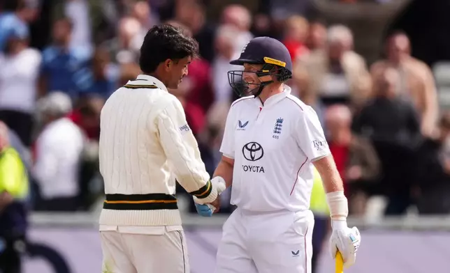 England's Joe Root and Pakistan's Razaullah shake hands following England's victory on day four of the third cricket Test at Edgbaston, in Birmingham, England, Saturday, Sept. 12, 2026. (Mike Egerton/PA via AP)