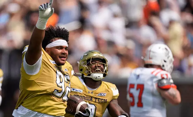 Georgia Tech defensive lineman Christian Speakman (92) celebrtes his fumble recovery against Mercer in the first half of an NCAA college football game, Saturday, Sept. 19, 2026, in Atlanta. (AP Photo/Mike Stewart)