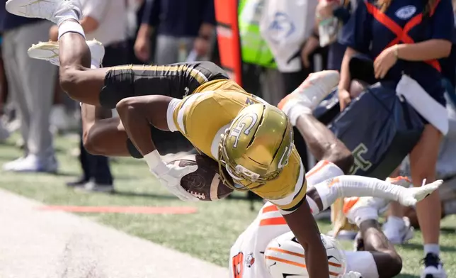 Georgia Tech wide receiver Dalen Penson (7) makes the catch agaimnst Mercer cornerback Cameron Goggins (8) in the first half of an NCAA college football game, Saturday, Sept. 19, 2026, in Atlanta. (AP Photo/Mike Stewart)