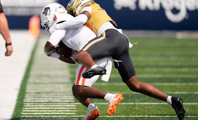 Georgia Tech defensive back Daiquan White (4) hits Mercer wide receiver Eric Rasheed (0) in the first half of an NCAA college football game, Saturday, Sept. 19, 2026, in Atlanta. (AP Photo/Mike Stewart)