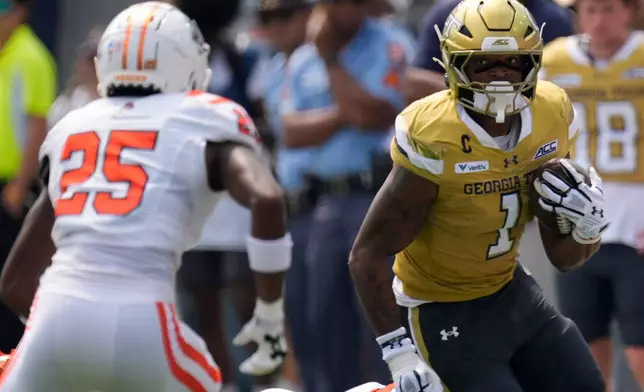 Georgia Tech running back Trelain Maddox (1) runs against Mercer linebacker Evin McDowell (25) in the first half of an NCAA college football game, Saturday, Sept. 19, 2026, in Atlanta. (AP Photo/Mike Stewart)