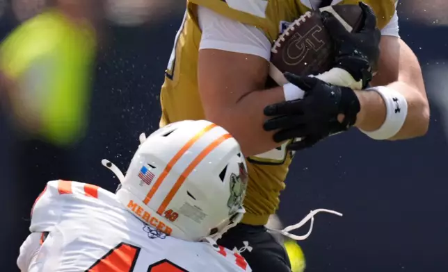 Georgia Tech tight end Kevin Roche Jr. (86) makes a catch against Mercer linebacker Ronin Dangler (48) in the first half of an NCAA college football game, Saturday, Sept. 19, 2026, in Atlanta. (AP Photo/Mike Stewart)