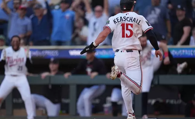 Minnesota Twins' Luke Keaschall (15) scores the game-winning run on a single by Victor Caratini in the 13th inning of a baseball game against the New York Yankees, Wednesday, Sept. 16, 2026, in Minneapolis. (AP Photo/Abbie Parr)