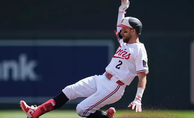 Minnesota Twins' Kody Clemens (2) slides into second base safely after hitting a single and advancing on a fielding error by New York Yankees center fielder Spencer Jones during the fourth inning of a baseball game, Wednesday, Sept. 16, 2026, in Minneapolis. (AP Photo/Abbie Parr)