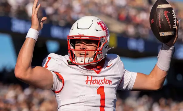 Houston quarterback Conner Weigman (1) celebrates his touchdown against Georgia Southern in the first half of an NCAA football game, Saturday, Sept. 26, 2026, in Statesboro, Ga. (AP Photo/Mike Stewart)