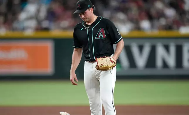 Arizona Diamondbacks starting pitcher Brandon Pfaadt tosses down the rosin bag during the fifth inning of a baseball game against the Texas Rangers, Saturday, Sept. 12, 2026, in Phoenix. (AP Photo/Ross D. Franklin)