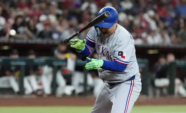 Texas Rangers designated hitter Joc Pederson reacts to being hit by a pitch against the Arizona Diamondbacks during the fifth inning of a baseball game, Saturday, Sept. 12, 2026, in Phoenix. (AP Photo/Ross D. Franklin)
