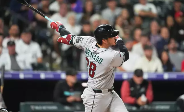 Arizona Diamondbacks' Nolan Arenado watches his solo home run off Colorado Rockies relief pitcher Zach Agnos in the seventh inning of a baseball game Tuesday, Sept. 22, 2026, in Denver. (AP Photo/David Zalubowski)