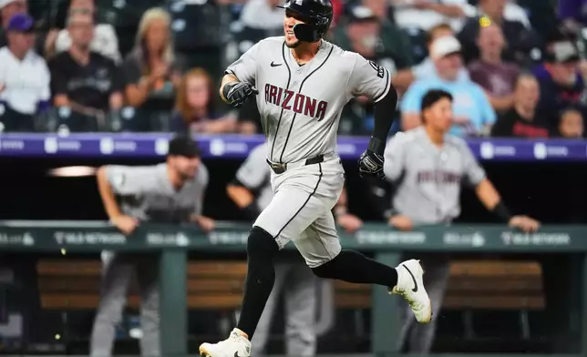 Arizona Diamondbacks' Ildemaro Vargas scores on a double hit by Gabriel Moreno off Colorado Rockies starting pitcher Kyle Freeland in the first inning of a baseball game Tuesday, Sept. 22, 2026, in Denver. (AP Photo/David Zalubowski)