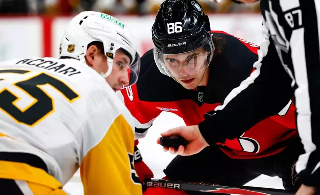 FILE - New Jersey Devils center Jack Hughes (86) before a face off against Pittsburgh Penguins center Noel Acciari (55) during the second period of an NHL hockey game, April 9, 2026, in Newark, N.J. (AP Photo/Noah K. Murray, File)