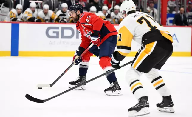 FILE - Washington Capitals right wing Tom Wilson (43) skates with the puck against Pittsburgh Penguins center Evgeni Malkin (71) during the first period of an NHL hockey game, April 12, 2026, in Washington. (AP Photo/Nick Wass, File)