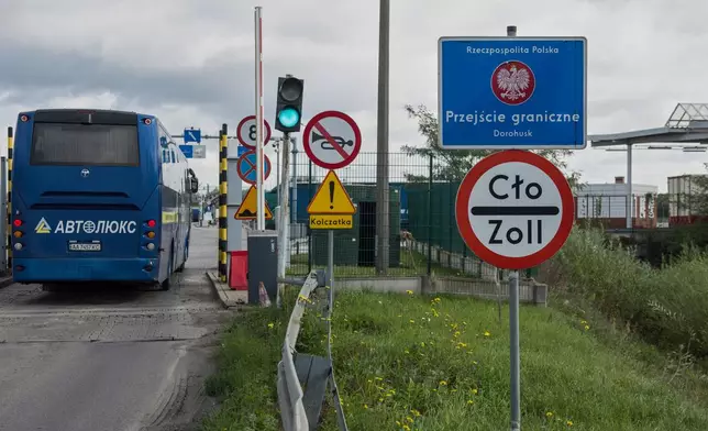 A bus drives past the security checkpoint at the Dorohusk-Jagodzin border crossing between Poland and Ukraine, Dorohusk, Poland, on Sept. 24, 2026. (AP Photo/Attila Husejnow)