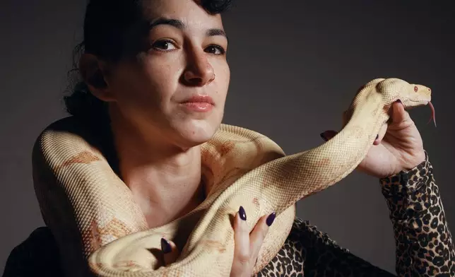 Performance artist Zoe Ziegfeld who plays the part of a snake charmer poses for a portrait with a snake during auditions to select a snake for a part in an adaptation of Mozart’s “Così fan tutte," at the Metropolitan Opera in New York, Friday, Aug. 28, 2026. (AP Photo/Andres Kudacki)