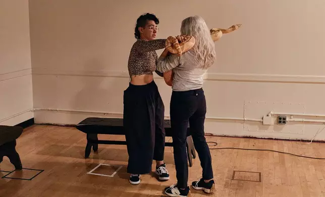 Animal talent expert Nancy Novograd, right, interacts with performance artist Zoe Ziegfeld, who plays the part of a snake charmer, during auditions to select a snake for a part in an adaptation of Mozart’s “Così fan tutte," at the Metropolitan Opera in New York, Friday, Aug. 28, 2026. (AP Photo/Andres Kudacki)