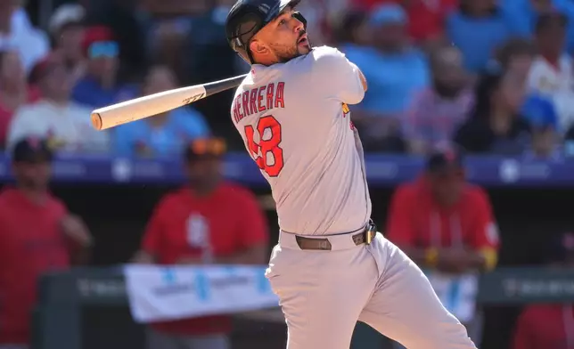 St. Louis Cardinals' Iván Herrera watches his double which drove in two runs off Colorado Rockies relief pitcher Nick Frasso in the eighth inning of a baseball game Sunday, Sept. 6, 2026, in Denver. (AP Photo/David Zalubowski)