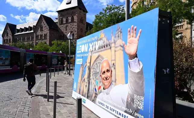 A banner announces the upcoming visit of Pope Leo XIV in Metz eastern France, Tuesday, Sept 15, 2026 as part of his official visit to France from Sept. 26 to 28. (AP Photo/Pascal Bastien)