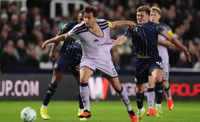 Newcastle United's Nico Gonzalez, left, and Millwall's Daniel Kelly battle for the ball during the English League Cup third round soccer match in London, Tuesday Sept. 8, 2026. (John Walton/PA via AP)