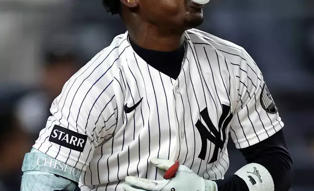 New York Yankees' Jazz Chisholm Jr. blows a bubble after striking out in the second inning during the second baseball game of a doubleheader against the Tampa Bay Rays, Tuesday, Sept. 22, 2026, in New York. (AP Photo/Adam Hunger)