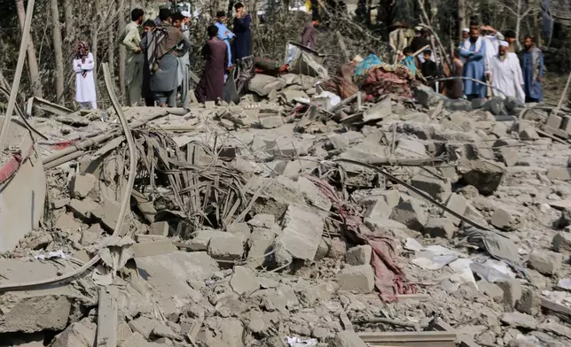 Residents inspect the rubble of a house destroyed in a strike in Patan village, Kunar province, eastern Afghanistan, Monday, Sept. 21, 2026. (AP Photo/Shafiullah Kakar)