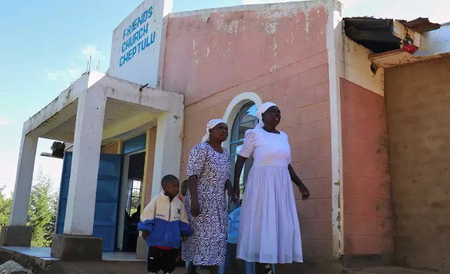 People walk outside Friends Church Cheptulu in Kaimosi, Kenya after a service, in Kaimosi, Kenya, Sunday, Sept. 20, 2026. (AP Photo/Jackson Njehia)