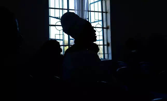 Quakerism faithful are silhouetted while singing during a church service in Kaimosi, Kenya, Sunday, Sept. 20, 2026. (AP Photo/Jackson Njehia)