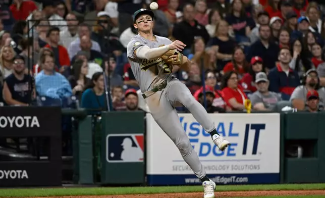 Athletics' Zack Gelof throws out Cleveland Guardians' Jo Adell at first base during the sixth inning of a baseball game, Saturday, Sept. 19, 2026, in Cleveland. (AP Photo/Phil Long)