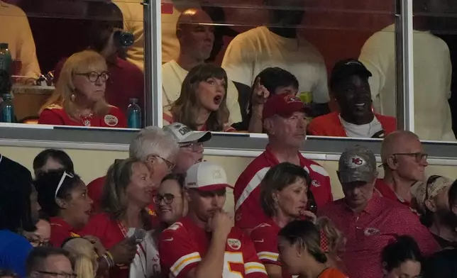 Taylor Swift, center, reacts while watching the first half of an NFL football game between the Kansas City Chiefs and the Denver Broncos, Monday, Sept. 14, 2026, in Kansas City, Mo. (AP Photo/Charlie Riedel)
