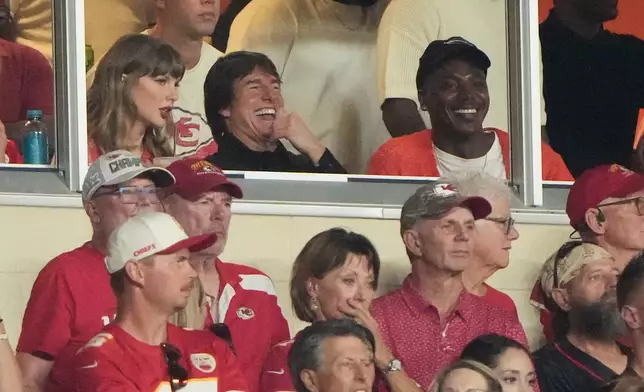 Taylor Swift, left, sits with Tom Cruise, center, while watching the first half of an NFL football game between the Kansas City Chiefs and the Denver Broncos, Monday, Sept. 14, 2026, in Kansas City, Mo. (AP Photo/Charlie Riedel)