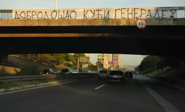 Cars move along under a bridge with a banner on it reading: "Welcome home, General! (former Bosnian Serb wartime general Ratko Mladic)" in Belgrade, Serbia, Thursday, Sept. 3, 2026. (AP Photo/Darko Vojinovic)
