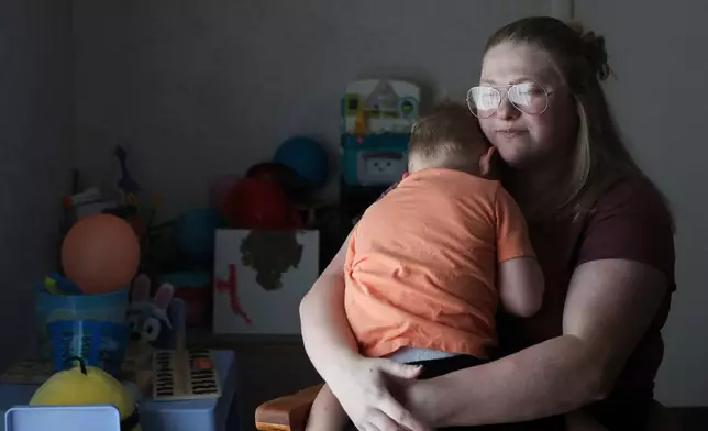 Meygan Maloney poses for a portrait with her son Callum Wilson, 3, Friday, Aug. 28, 2026, at their home in Hartford City, Ind. (AP Photo/Cara Penquite)