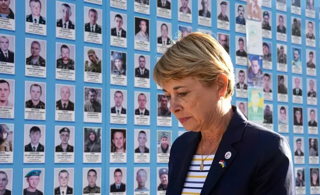 Monaco's Foreign Minister Isabelle Berro-Amadei walks past the Memory Wall of Fallen Defenders of Ukraine in Kyiv, Ukraine, Tuesday, Sept. 15, 2026. (AP Photo/Efrem Lukatsky)