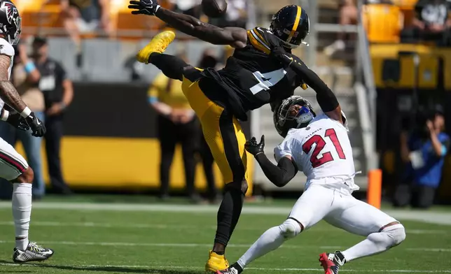 Atlanta Falcons cornerback Mike Hughes (21) breaks up a pass intended for Pittsburgh Steelers wide receiver Dk Metcalf (4) during an NFL football game, Sunday, Sept. 13, 2026, in Pittsburgh. (AP Photo/Gene J. Puskar)