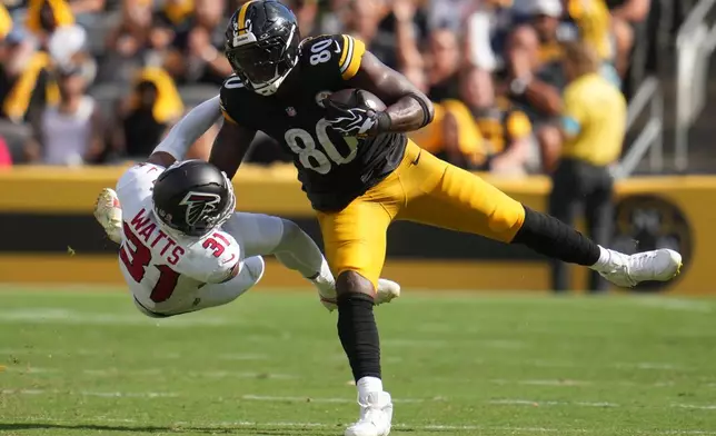 Pittsburgh Steelers tight end Darnell Washington (80) stiff arms Atlanta Falcons safety Xavier Watts (31) during an NFL football game, Sunday, Sept. 13, 2026, in Pittsburgh. (AP Photo/Gene J. Puskar)