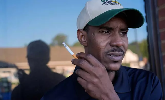 Samba Diallo, a Mauritanian immigrant, pauses for a cigarette at a convenience store and gas station after his regular appointment at an Immigration and Customs Enforcement office in Cincinnati, Monday, Sept. 14, 2026. (AP Photo/Carolyn Kaster)