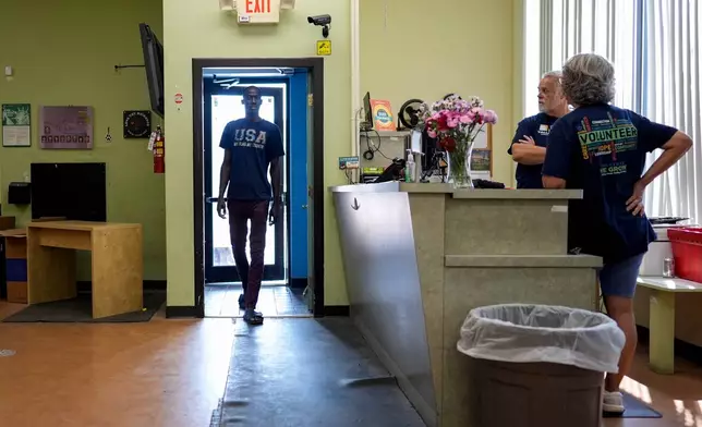 Wearing a "USA MY FLAG MY COUNTRY" T-shirt, a client walks into the Valley Interfaith Community Resource Center in Lockland, Ohio, Friday, July 31, 2026. (AP Photo/Carolyn Kaster)