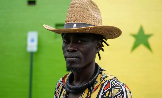 Mohamed, a Senegalese immigrant, pauses as he walks through the parking lot of Touba Tedoungal African Restaurant, Friday, July 31, 2026, in Lockland, Ohio, which has for decades been home to a small population of West Africans. (AP Photo/Carolyn Kaster)