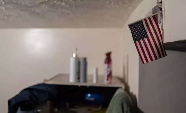 An American flag decorates Samba Diallo's bedroom in his shared apartment in Lockland, Ohio, Friday, July 17, 2026. Lockland had for decades been home to a small population of West Africans who'd come to Ohio in the 1990s. (AP Photo/Carolyn Kaster)
