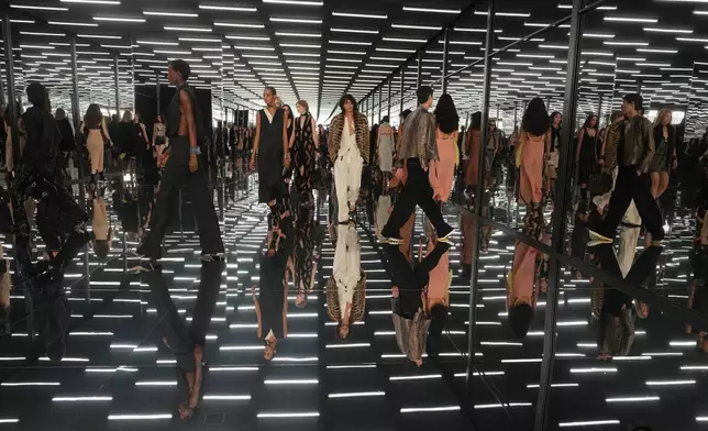 Models wear creations as part of the Fendi Spring/Summer 2027 Women's collection presented in Milan, Italy, Wednesday, Sept. 23, 2026. (AP Photo/Antonio Calanni)