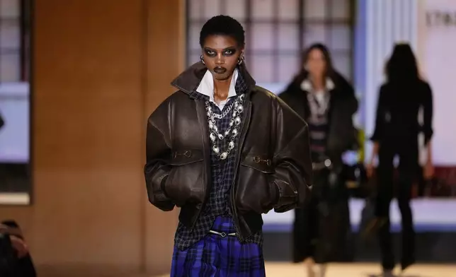A model wears a creation part of the Gucci women's Spring-Summer 2027 collection, presented in Milan, Italy, Friday, Sept. 25, 2026. (AP Photo/Luca Bruno)