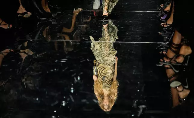 A model wears a creation part of the Roberto Cavalli women's Spring-Summer 2027 collection, presented in Milan, Italy, Thursday, Sept. 24, 2026. (AP Photo/Luca Bruno).