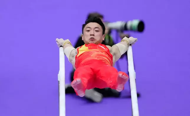 China's Zou Jingyuan competes on the parallel bars during the men's team artistic gymnastics final at the Asian Games in Nagoya, Japan, Wednesday, Sept. 23, 2026. (AP Photo/Eugene Hoshiko)