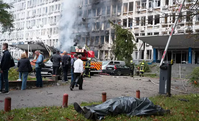 The body of a victim lies on the ground following a Russian drone strike in Kyiv, Ukraine, Wednesday, Sept. 23, 2026. (AP Photo/Danylo Antoniuk)
