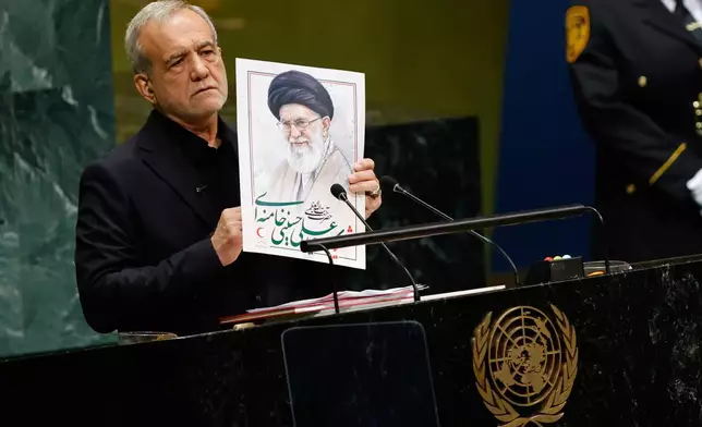 Iran's President Masoud Pezeshkian holds an image of late Iranian Supreme Leader Ayatollah Ali Khamenei during the 81st session of the United Nations General Assembly at United Nations headquarters, Wednesday, Sept. 23, 2026. (AP Photo/Stefan Jeremiah)