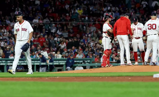 Boston Red Sox pitcher Jedixson Paez, left, is taken out of the game during the fourth inning of a baseball game against the Seattle Mariners, Tuesday, Sept. 1, 2026, in Boston. (AP Photo/Mark Stockwell)