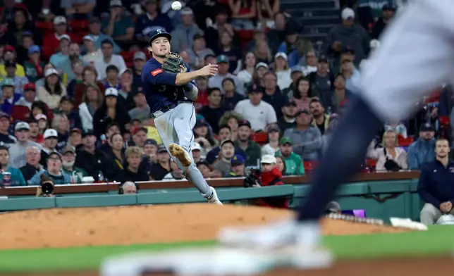Seattle Mariners third baseman Brock Rodden throws to first base for an attempted out during the sixth inning of a baseball game against the Boston Red Sox, Tuesday, Sept. 1, 2026, in Boston. (AP Photo/Mark Stockwell)